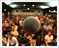 photo - microphone in front of large crowd