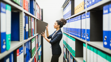 Woman looking through shelves of records
