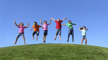 Group of multi-ethnic kids jumping together