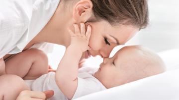 Young Caucasian mother smiling at her baby