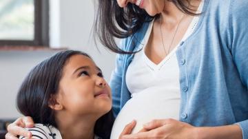Pregnant Woman and child holding belly