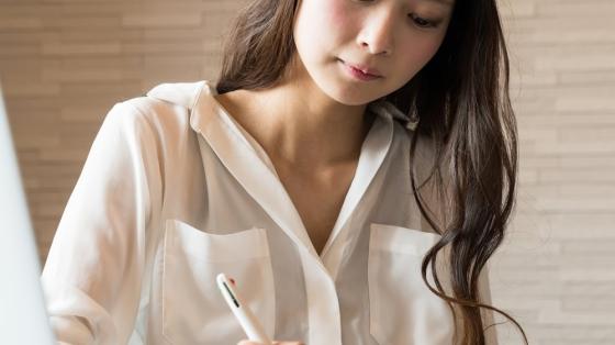 Lady writing on desk