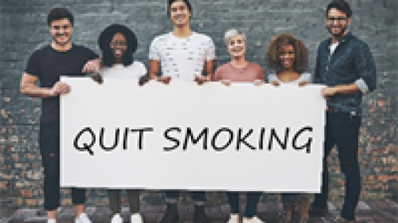 Group Holding Quit Smoking Sign