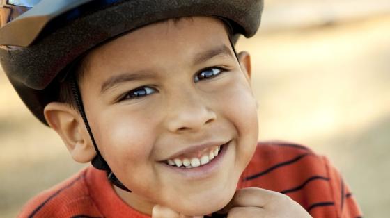 Kid strapping on helmet