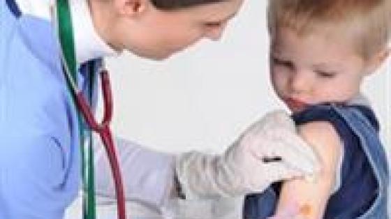 Boy getting a shot by doctor