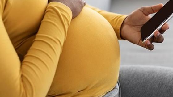 Pregnant Woman Holding Phone