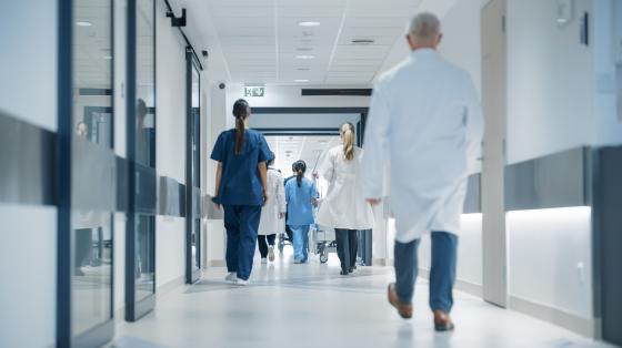 hospital hallway with medical professionals walking by