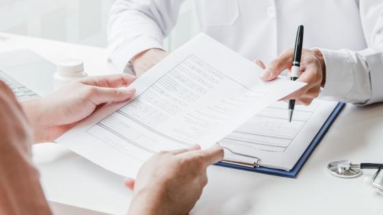 two people working on forms together