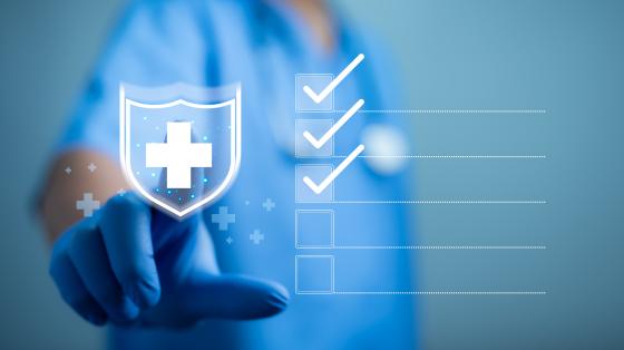 first aid symbol, check marks, and medical professional in the background