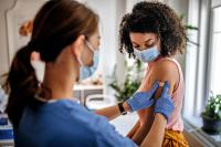 Nurse applying bandage on arm