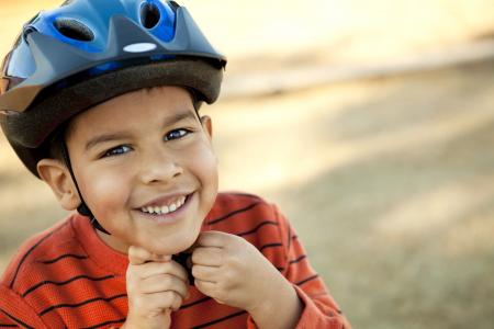 Boy Putting on Bike Helmet
