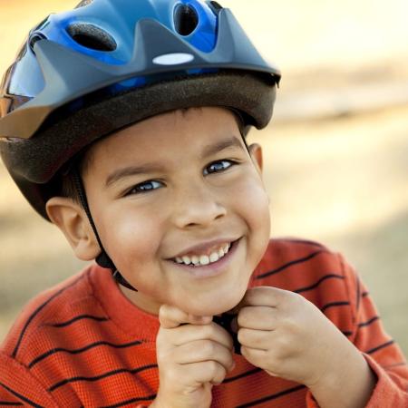Kid strapping on helmet