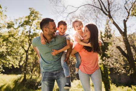 Mother and Dad with kids on backs