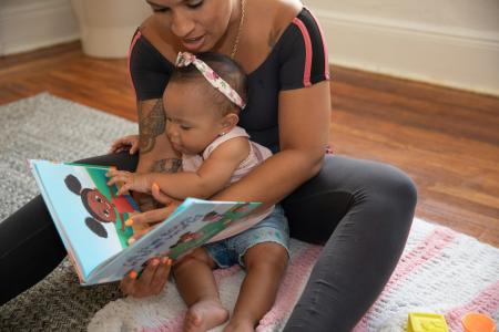 woman reading to baby