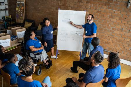 group of people collaborating near a white board
