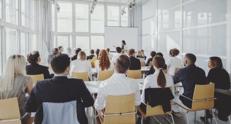 person presenting to group of people